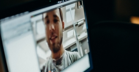 a macbook displaying a zoom call