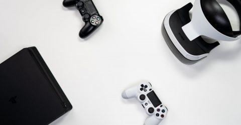 a playstation 5 controller next to a playstation 4 controller